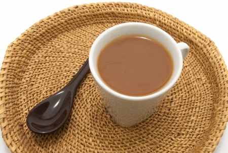 A spoon and a cup of lime tea on isolated white backgroundの写真素材