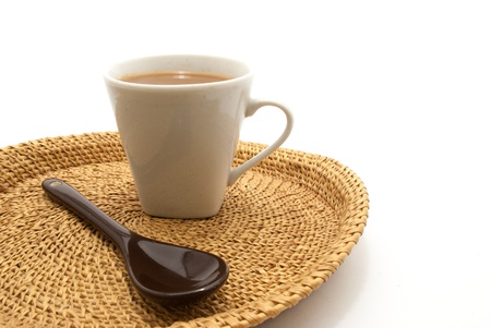 A spoon and a cup of lime tea on isolated white backgroundの写真素材