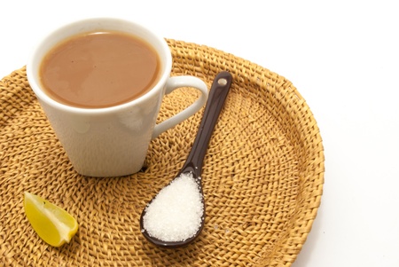 A spoon and a cup of lime tea on isolated white backgroundの写真素材