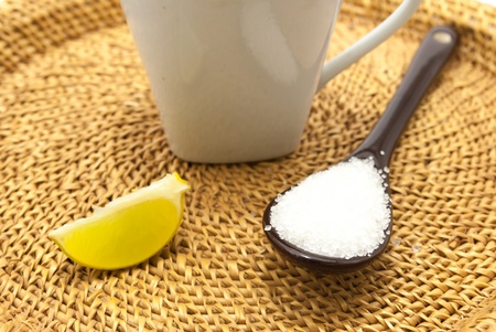 A spoon and a cup of lime tea on isolated white backgroundの写真素材