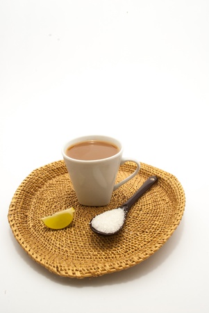 A spoon and a cup of lime tea on isolated white backgroundの写真素材