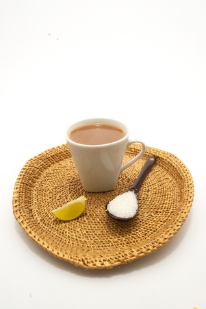 A spoon and a cup of lime tea on isolated white backgroundの写真素材