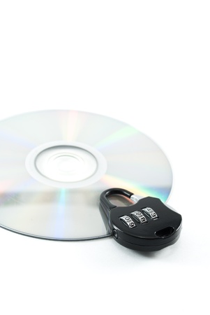 compact disk with a security lock on it conceptual isolated imageの写真素材