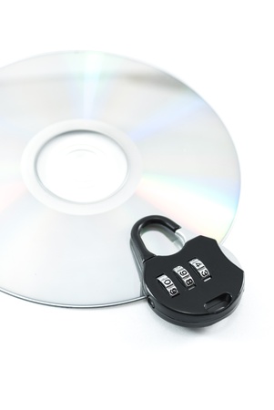 compact disk with a security lock on it conceptual isolated imageの写真素材