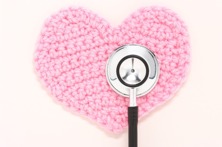 Stethoscope and pink knitted heart.の写真素材