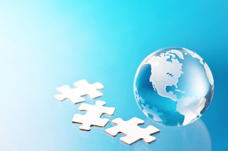 Glass globe and jigsaw puzzle pieces Building global business 
