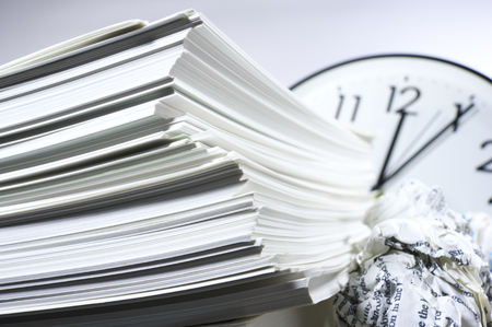 Heap of work  Stack of documents and clock 