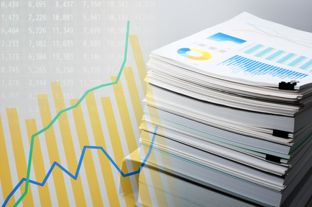 Documentation and data analysis. Business concept. Pile of documents on gray background. Graph and...