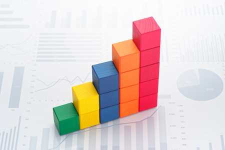 Statistical data analysis. Business data processing. Colorful toy block steps on many charts and...