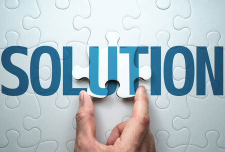 Finding the solution to problem. Business solution concept. Connecting last jigsaw puzzle piece.の写真素材