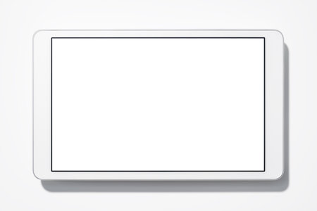 White tablet computer on white background with shadow. Blank screen. Top view.の写真素材