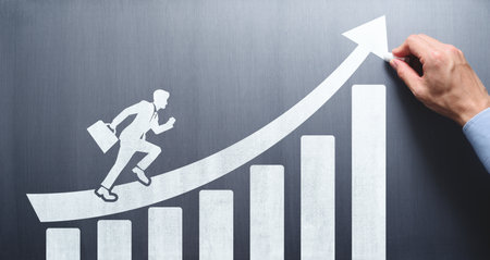 Business development and leadership concept. Business education. Drawing growth chart, arrow and running businessman on chalkboard.の写真素材