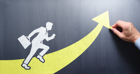 Business coaching and leadership concept. Personal development and success. Drawing growth arrow on chalkboard.の写真素材
