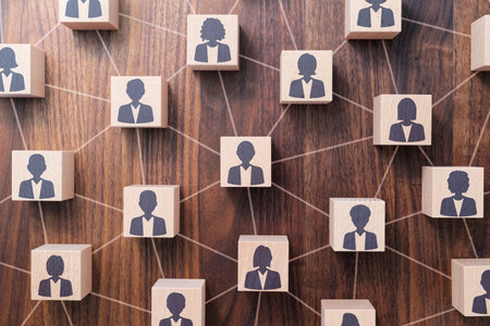People networking and communication concept. Many wood cubes with people icons. Top view of wood table.の写真素材