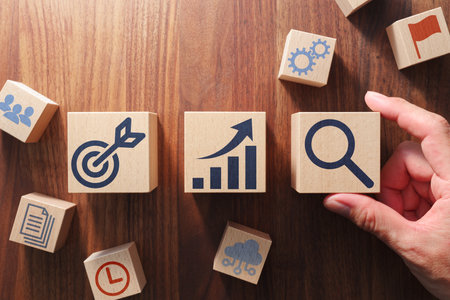 Business management and strategy concept. Putting wood cubes with icons. Top view of wood table.の写真素材