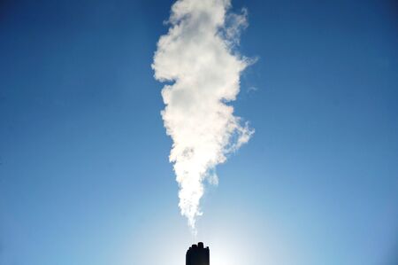 smoke from smoke stack with blue skyの写真素材
