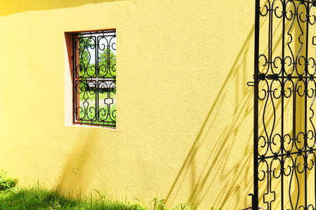 Yellow wall and iron gateの写真素材
