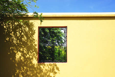Window on the yellow wallの写真素材