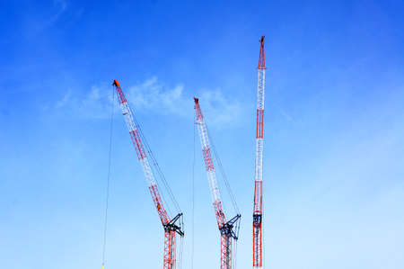 Skyscraper construction crane with blue skyの写真素材