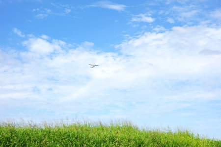 The grass hill against the blue skyの写真素材