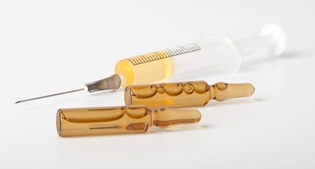 medical ampules and syringe isolated on white