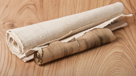 old scroll and the old canvas on wooden backgroundの写真素材