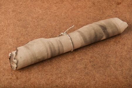 old scroll on an old wooden backgroundの写真素材