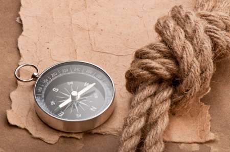 knot, a compass and a paper on the background of old paperの写真素材
