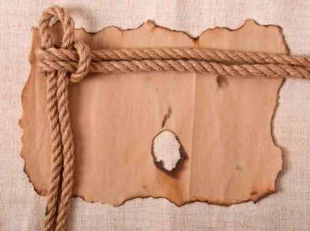 knot and old paper on the background of old clothの写真素材