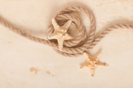starfish and rope on old paper backgroundの写真素材