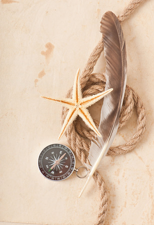 compass, rope and starfish on the old paper backgroundの写真素材