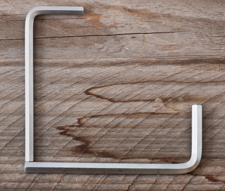 Metal work tools on the old wooden background