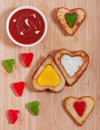 French fries and fresh vegetables chopped in the shape of a heart. Valentine's Dayの写真素材