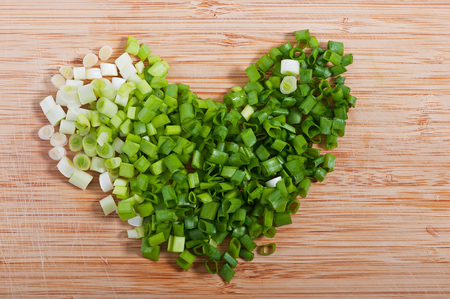 Green onions sliced on wooden bamboo background.の写真素材