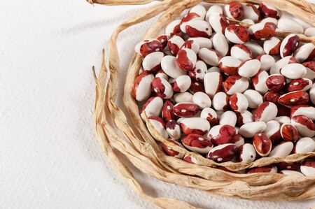 Ripe grain beans on a light background.
