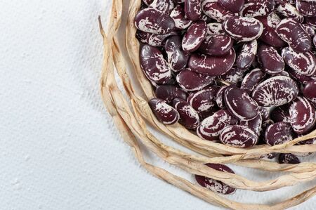 Ripe grain beans on a light background.