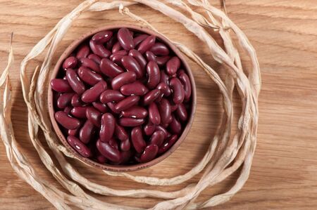 Ripe grain beans on a light background.