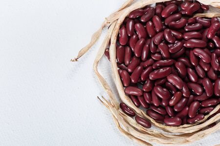 Ripe grain beans on a light background.の写真素材