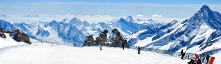 beautiful winter panorama of alps with skiers