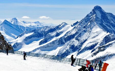 beautiful winter panorama of alps with skiers