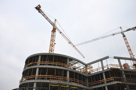 construction of building with crane and scaffolding