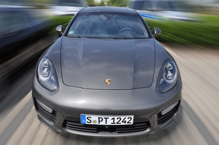 PRAGUE, THE CZECH REPUBLIC, 02.08.2015 - Speeding new Porsche Panamera on roadのeditorial素材