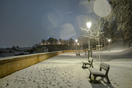 Night scenery of snowy Prague streets with bokehの写真素材