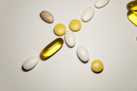 Quality food pills as nutrition supplements helps fit your health. Isolated on white backgroundの写真素材