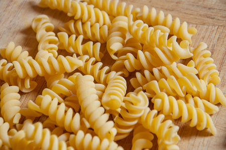 Closeup of italian fusilli. Pasta on wooden background. Fusilli is italian food.の写真素材