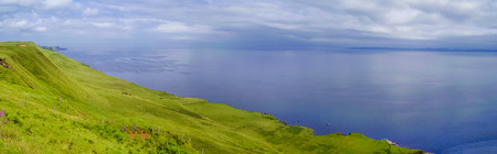 Beautiful panorama of Scotland coastline. Green Scotland Highlands and blu ocean. Skye Isle