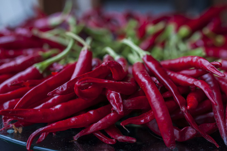 A lot of chilli peppers on wooden background. Hot red chilli pepper. Typical mexican food.