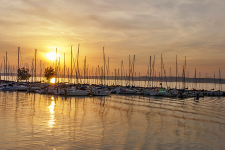 Sunset in harbor with yachts. Boats in port and the sunset in backgroundのeditorial素材