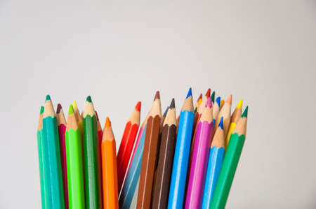 Colored pencils on isolated background. Closeup of colored pencils with a lot of colors.