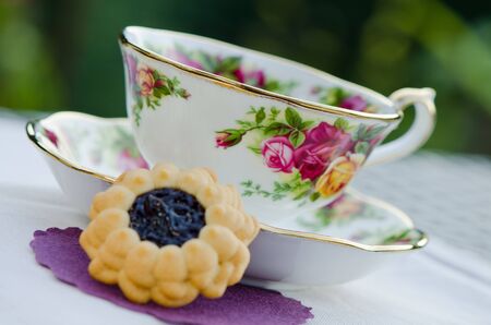 Colorful antique teacup with healthy green tea and healthy biscuitの写真素材